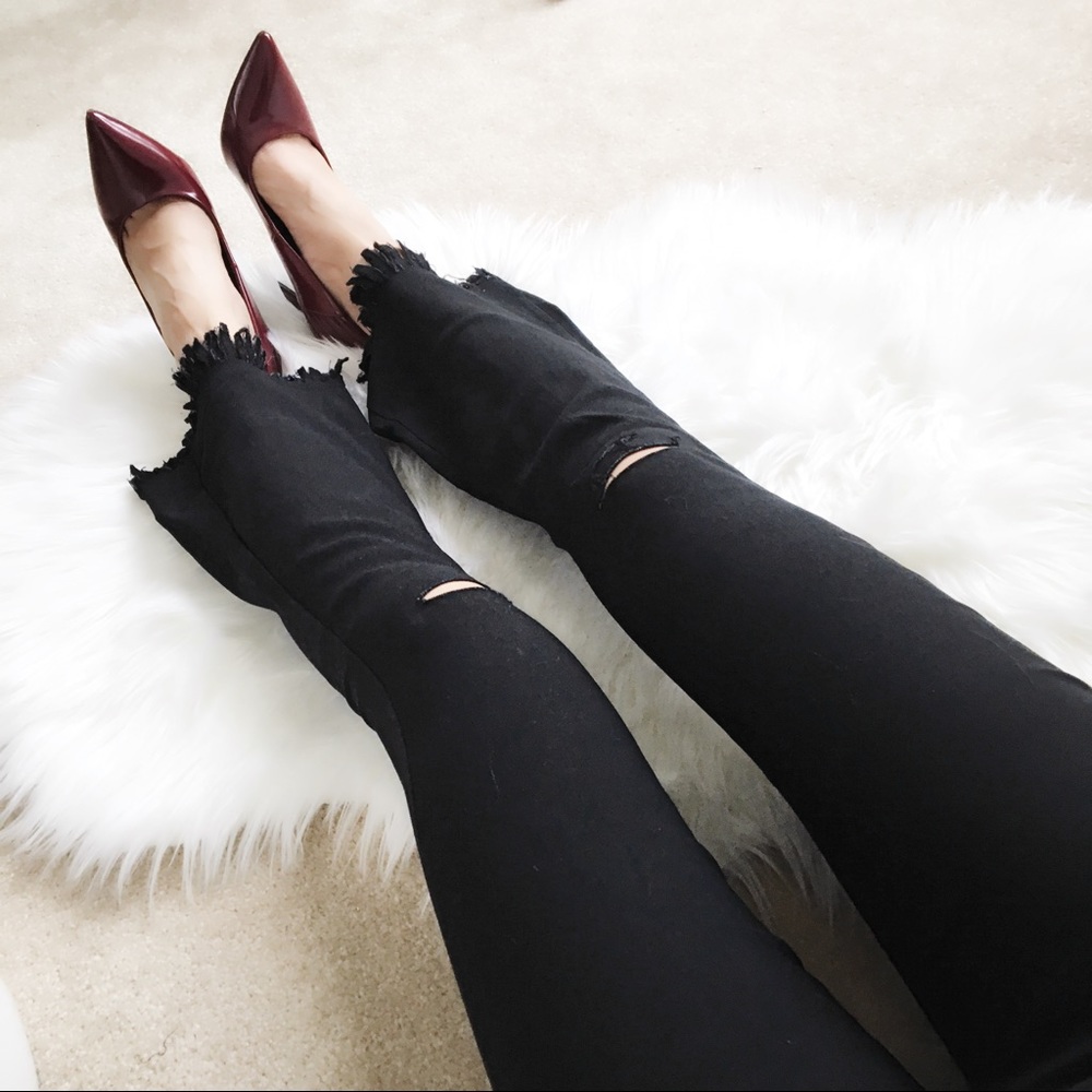 BLACK Frayed hem denim pants with cutout knee.